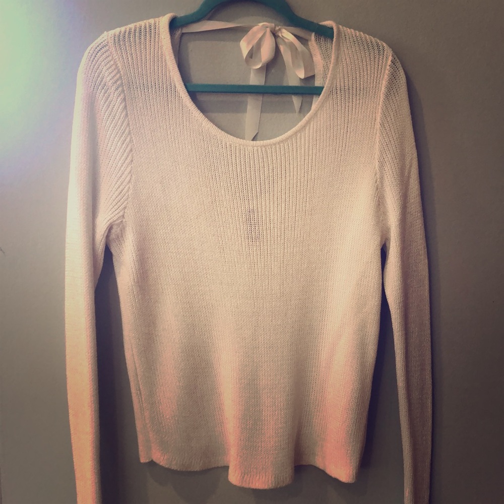 White, slouchy, open back sweater.